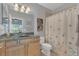 Bathroom featuring wood vanity with granite top and shower and tub combo with curtain at 10509 Belfry Cir, Orlando, FL 32832