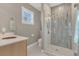 Bathroom featuring shower with glass doors, sink and window at 10509 Belfry Cir, Orlando, FL 32832