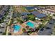 Aerial view of community with multiple pools, tennis courts, playground, and well-manicured grounds at 10509 Belfry Cir, Orlando, FL 32832