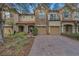 Charming townhome with a stone facade, two-car garage, and a well-manicured front yard at 10509 Belfry Cir, Orlando, FL 32832