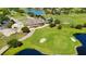 An aerial view of the community golf course, clubhouse and surrounding lush landscape at 10509 Belfry Cir, Orlando, FL 32832