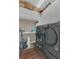 The laundry room has modern appliances with storage cabinets above at 10509 Belfry Cir, Orlando, FL 32832