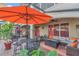 The covered patio features an orange umbrella, table with seating, and an outdoor sofa at 10509 Belfry Cir, Orlando, FL 32832