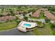 Aerial view of community pool area with a pergola and well-maintained landscaping near a lake at 10509 Belfry Cir, Orlando, FL 32832