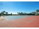 Community tennis courts with blue playing surface and red surround, perfect for tennis enthusiasts at 10509 Belfry Cir, Orlando, FL 32832