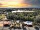 Aerial view of a property with a beautiful lake view, including trees and several buildings at 111 Water Tank Rd, Haines City, FL 33844