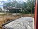 View of backyard showcasing home addition construction, featuring a shaded structure for a home addition at 111 Water Tank Rd, Haines City, FL 33844