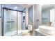 Bathroom featuring marble tiled walk-in shower with sliding glass door and modern sink at 111 Water Tank Rd, Haines City, FL 33844