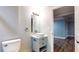 Bathroom featuring toilet, modern sink and vanity with a view to open room at 111 Water Tank Rd, Haines City, FL 33844