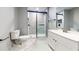 Bathroom featuring a modern glass shower with marble tile and a sleek white vanity at 111 Water Tank Rd, Haines City, FL 33844