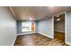 Bedroom featuring hardwood floors, fresh paint, white trim, and a large window at 111 Water Tank Rd, Haines City, FL 33844