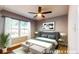 Staged bedroom with hardwood floors, ceiling fan, large window, and a calming neutral color palette at 111 Water Tank Rd, Haines City, FL 33844