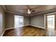 Bedroom with hardwood floors, ceiling fan, and easy access to the bathroom at 111 Water Tank Rd, Haines City, FL 33844