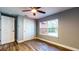 Bedroom with ceiling fan, wood flooring, base trim, closet and window at 111 Water Tank Rd, Haines City, FL 33844