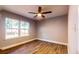 Bright bedroom with a ceiling fan, light-colored walls, and a large window for natural light at 111 Water Tank Rd, Haines City, FL 33844