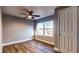 Bedroom featuring closet, wood flooring, base trim, window and ceiling fan at 111 Water Tank Rd, Haines City, FL 33844