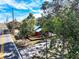 A cozy red home with a charming front deck, surrounded by lush greenery and a welcoming atmosphere at 111 Water Tank Rd, Haines City, FL 33844