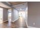 Hallway leading to rooms with wood flooring and access to kitchen and bathroom at 111 Water Tank Rd, Haines City, FL 33844