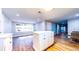 Kitchen island with white cabinets and drawers, adjacent to a dining area and kitchen with natural light at 111 Water Tank Rd, Haines City, FL 33844