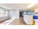 Bright open space featuring sunlight and hardwood floors, flowing into a kitchen with white cabinets at 111 Water Tank Rd, Haines City, FL 33844