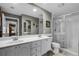 Bathroom featuring double sinks, a walk-in shower with glass door, and modern fixtures at 11716 Astilbe Dr, Orlando, FL 32827