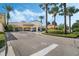 View of the community center entrance with gas pumps and covered entry to the building at 11716 Astilbe Dr, Orlando, FL 32827