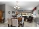 Elegant dining area with large table, chairs, chandelier, and a view to the outside patio at 11716 Astilbe Dr, Orlando, FL 32827