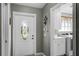 Home entryway with decorative glass door and view of laundry room with washer and dryer at 11716 Astilbe Dr, Orlando, FL 32827