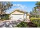 Charming home with a paved driveway, well-maintained landscaping, and a two-car garage at 11716 Astilbe Dr, Orlando, FL 32827