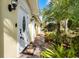 Inviting front entrance with a white door, brick walkway, and lush tropical landscaping at 11716 Astilbe Dr, Orlando, FL 32827