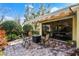 Cozy brick patio with a retractable awning, outdoor seating and fireplace, perfect for relaxing at 11716 Astilbe Dr, Orlando, FL 32827