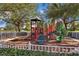 Community playground surrounded by mature trees and manicured landscaping offers a fun and safe play area for  at 11716 Astilbe Dr, Orlando, FL 32827