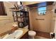 Functional bathroom with a granite vanity, tiled shower, and convenient storage shelves at 11801 Lake Susan Ct, Clermont, FL 34711