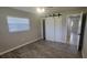 Cozy bedroom with a barn door closet and wood-look tile flooring at 11801 Lake Susan Ct, Clermont, FL 34711