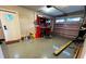 A functional garage offers ample workspace with overhead lighting and epoxy flooring at 11801 Lake Susan Ct, Clermont, FL 34711