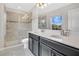 Bathroom with a double vanity, walk-in shower with glass doors, and tiled floors at 11867 Pulitzer Pl, Orlando, FL 32832