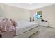 Bedroom with a plush bed, TV, white dresser, and a window with view of tropical beach scene at 11867 Pulitzer Pl, Orlando, FL 32832