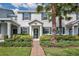 Charming townhouse exterior showcasing a beautifully landscaped front yard and inviting entrance at 11867 Pulitzer Pl, Orlando, FL 32832