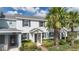 Charming townhome with a landscaped front yard, complemented by green shutters and a welcoming entrance at 11867 Pulitzer Pl, Orlando, FL 32832