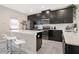 Well-appointed kitchen featuring dark cabinetry, stainless steel appliances, and a functional layout at 11867 Pulitzer Pl, Orlando, FL 32832