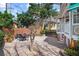 Brick patio with a dining set, a garden bed, and a view of the neighboring home at 1508 Delaney Ave, Orlando, FL 32806