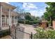 Serene backyard with a brick patio, wrought iron gate, and lush greenery at 1508 Delaney Ave, Orlando, FL 32806