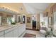 Well-lit bathroom with double sinks, white cabinets, and a large window at 1508 Delaney Ave, Orlando, FL 32806