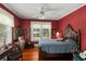 Bright bedroom features a ceiling fan, hardwood floors, and natural light from the window at 1508 Delaney Ave, Orlando, FL 32806