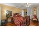 Cozy bedroom with hardwood floors, a ceiling fan, and closet with bi-fold doors at 1508 Delaney Ave, Orlando, FL 32806