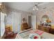 Cozy bedroom with hardwood floors, floral wallpaper, and natural light from the window at 1508 Delaney Ave, Orlando, FL 32806