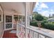 Covered porch with a ceiling fan overlooking a brick patio and landscaped backyard at 1508 Delaney Ave, Orlando, FL 32806