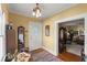 Warm foyer with hardwood floors, vintage light fixture, and inviting entrance to the living spaces at 1508 Delaney Ave, Orlando, FL 32806