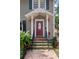 Inviting front entry with brick steps, lush greenery, and an elegant door with glass detail at 1508 Delaney Ave, Orlando, FL 32806