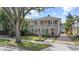 Charming two-story home featuring a well-manicured lawn, awnings, and a welcoming red front door at 1508 Delaney Ave, Orlando, FL 32806